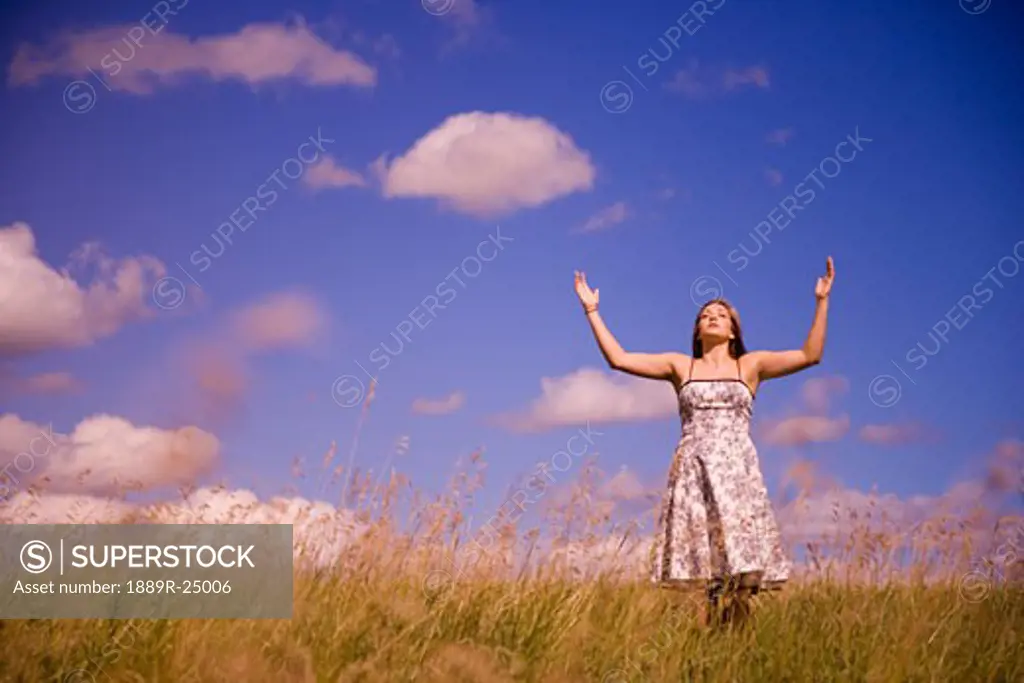 Women with arms raised in worship