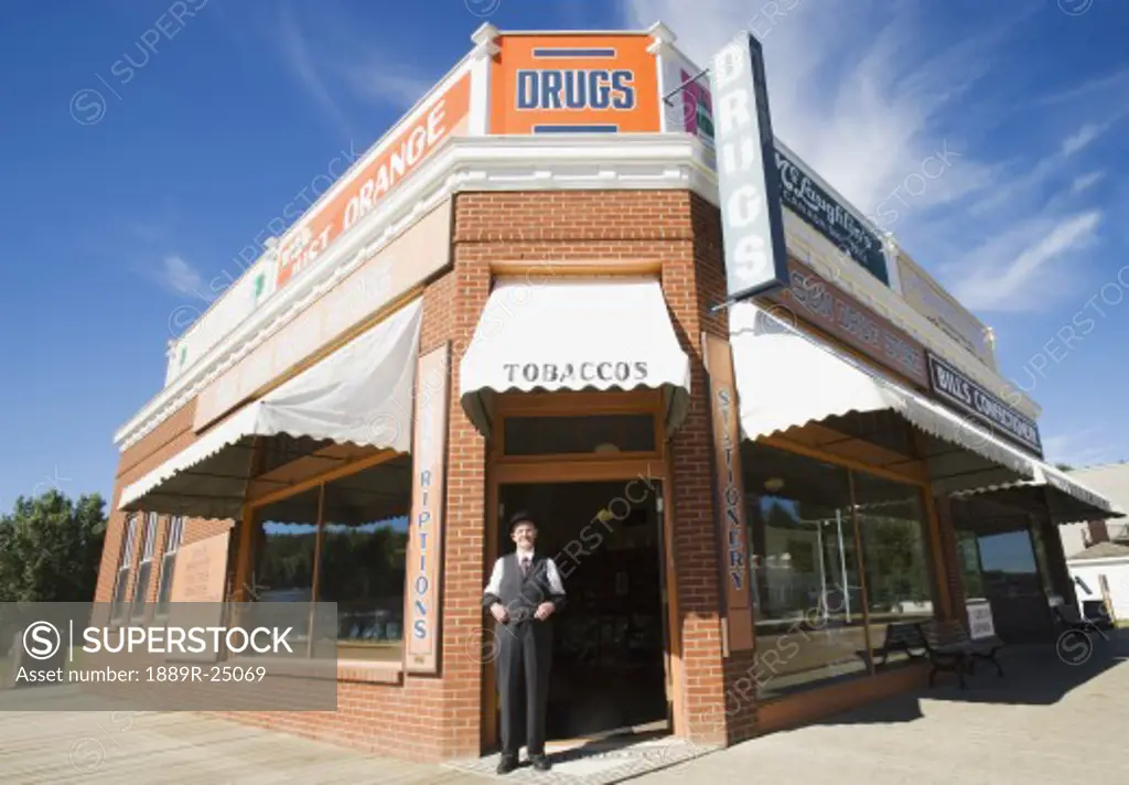 Man in front of historical drugstore