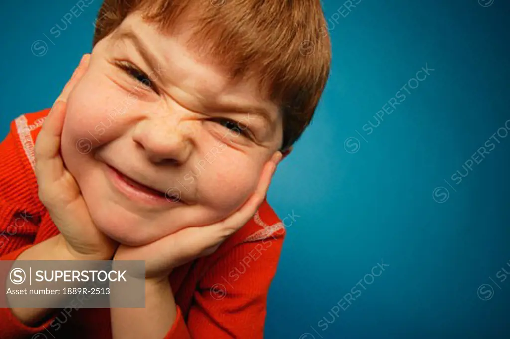 Boy with cheesy expression