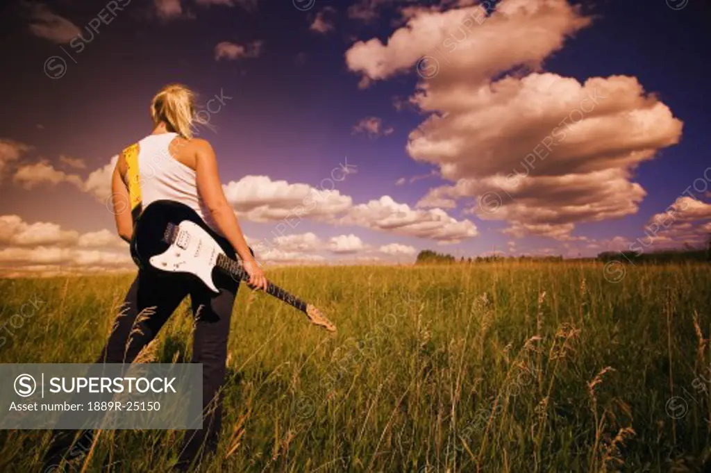 Young woman with electric guitar