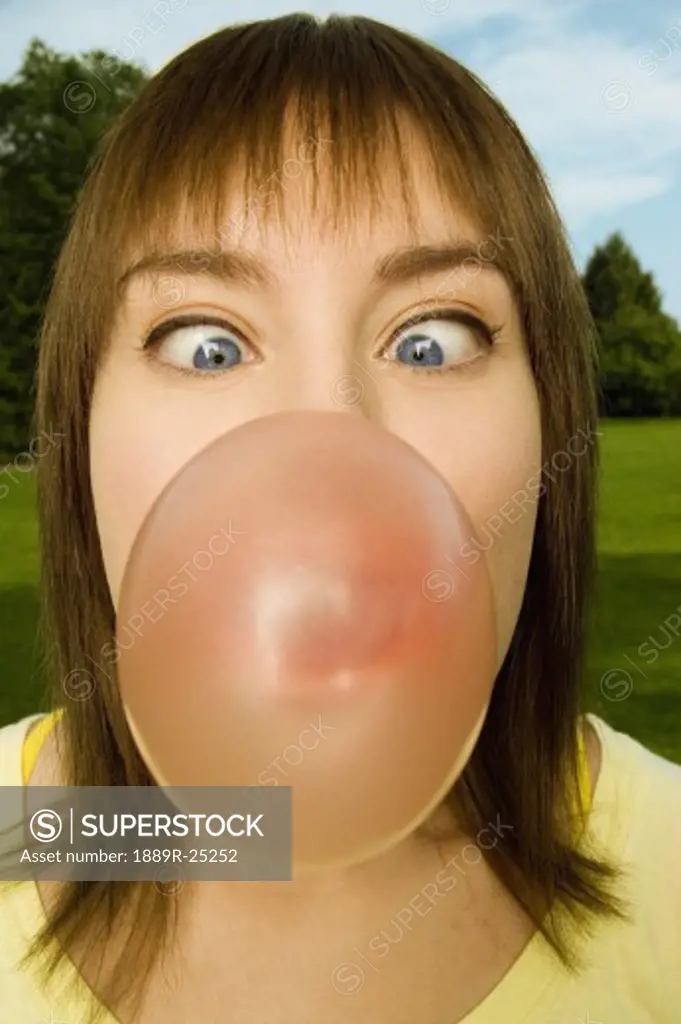 Woman blowing bubblegum