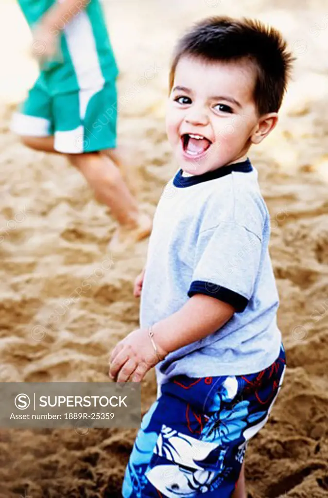 Young boy playing in sand