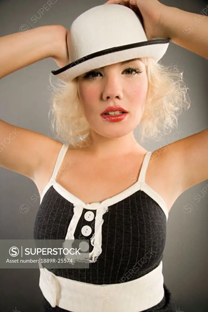 Young woman posing with hat