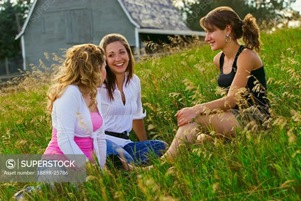 Young women talking in field