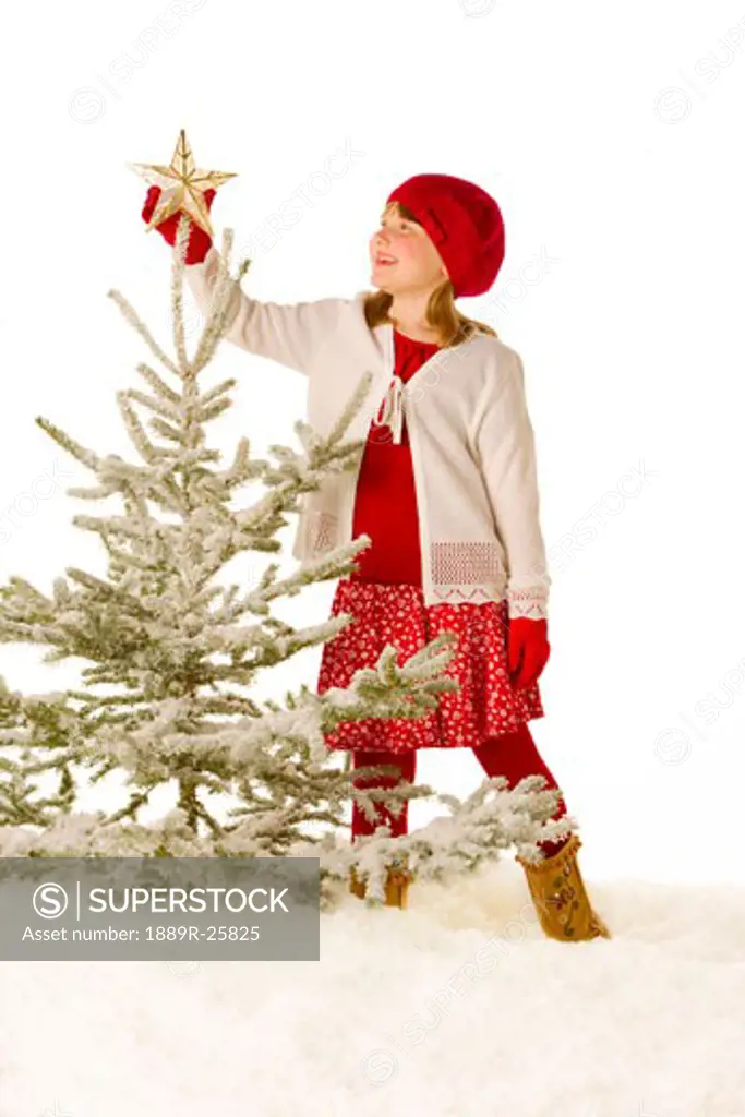 Girl decorating a tree
