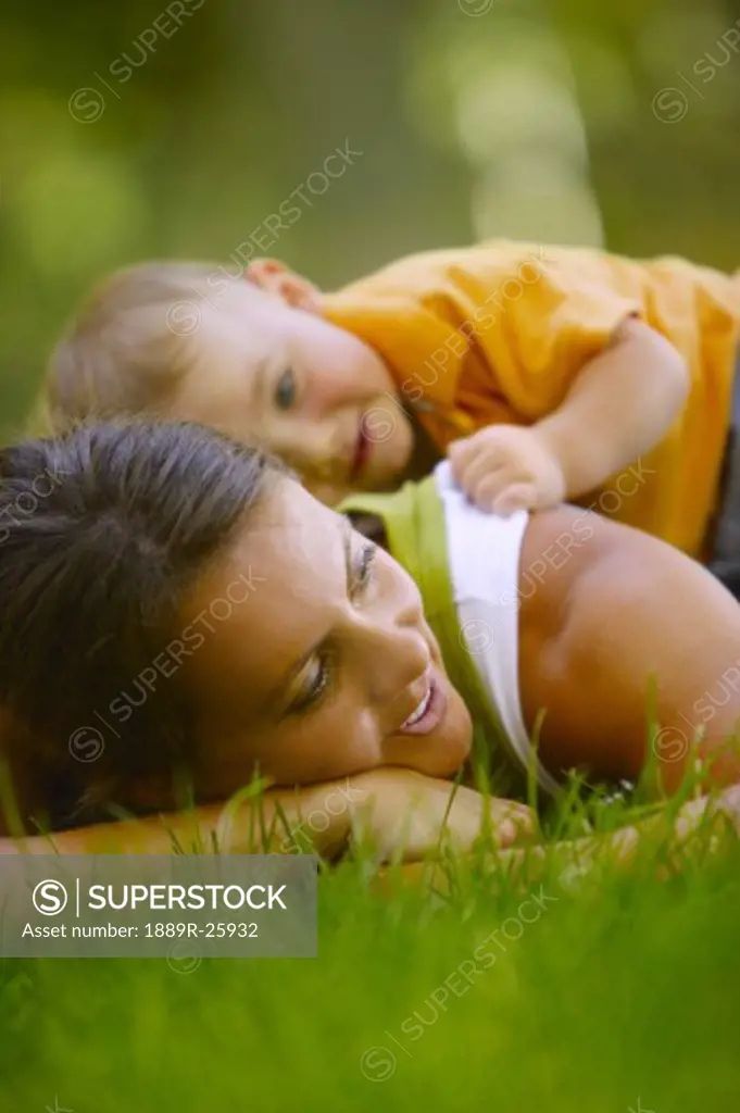 Toddler laying on mother's back