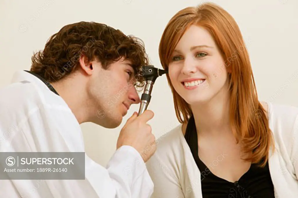 Doctor examining young woman
