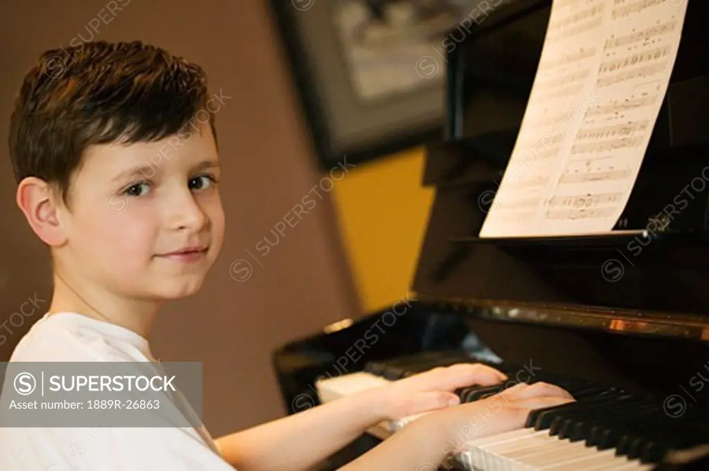 Young boy playing piano