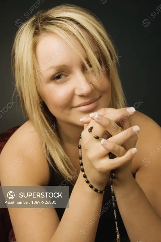 Woman holding Rosary beads