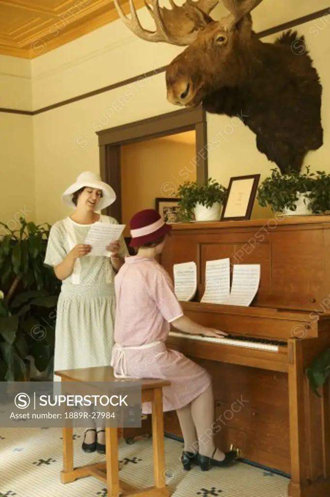 Women playing the piano and singing