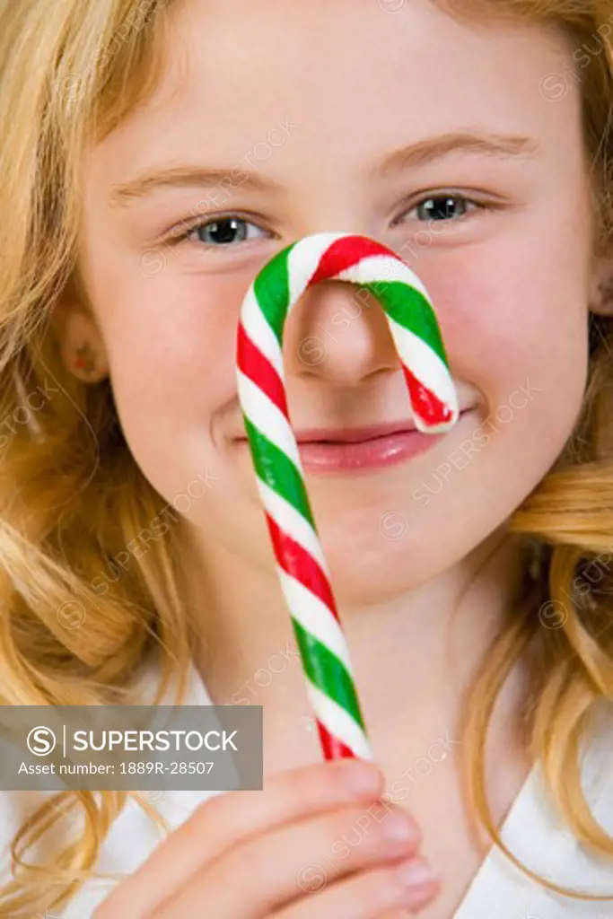 Girl holding a candy cane