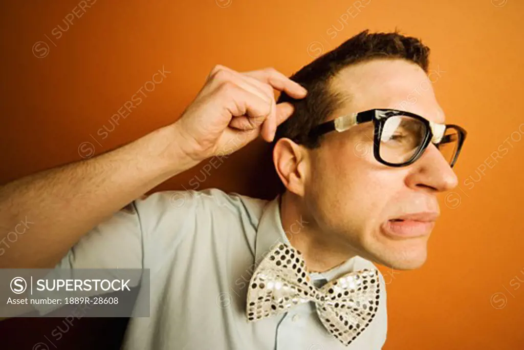 Man wearing taped glasses and a bow tie