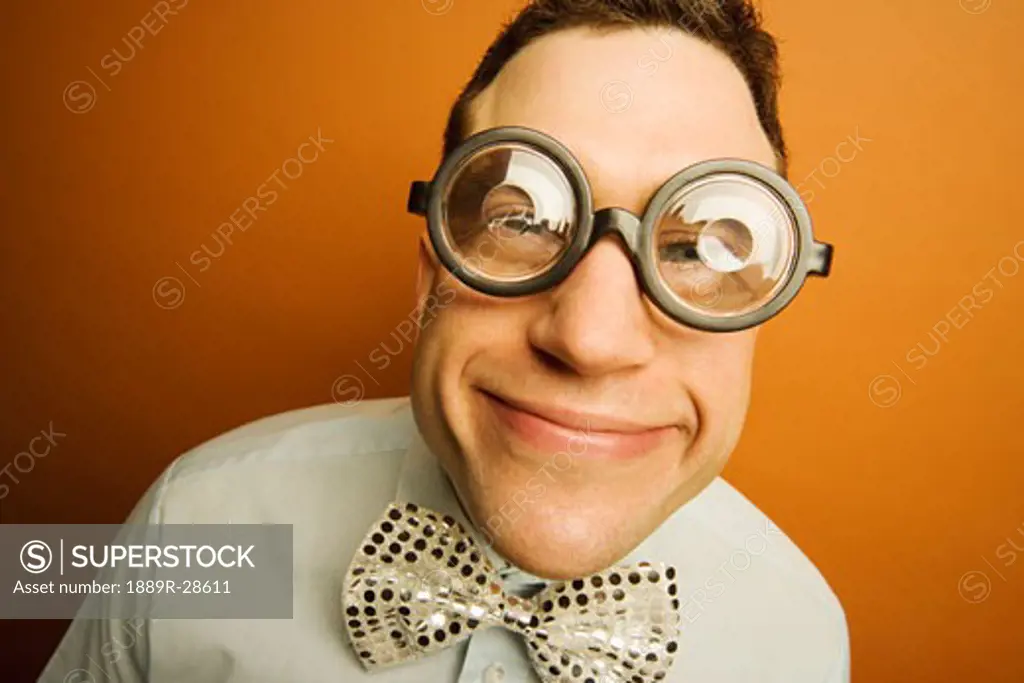 Man wearing thick glasses and a bow tie