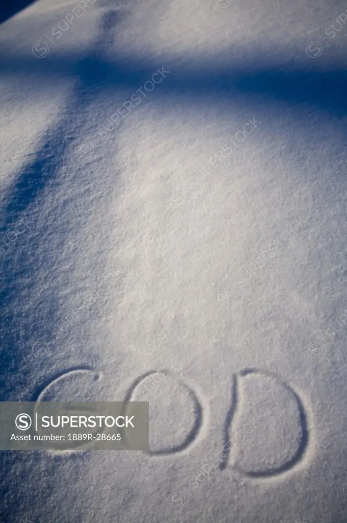 God written in the snow and a shadow of a cross