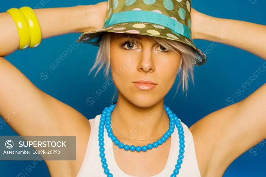 Woman wearing a hat and jewellery