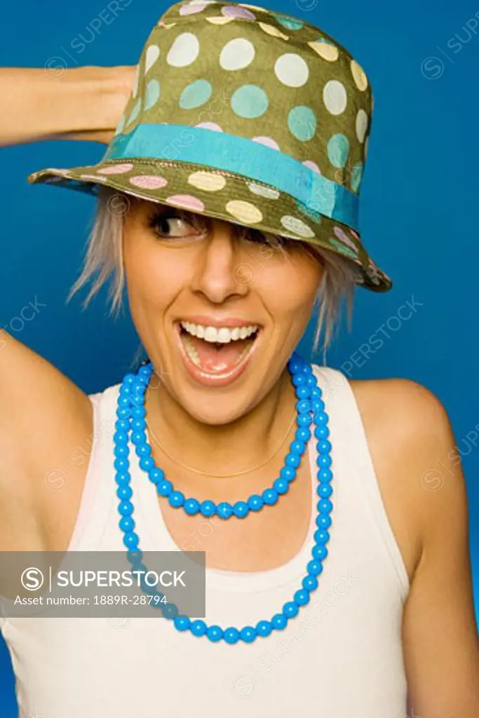 Woman wearing a hat and necklace