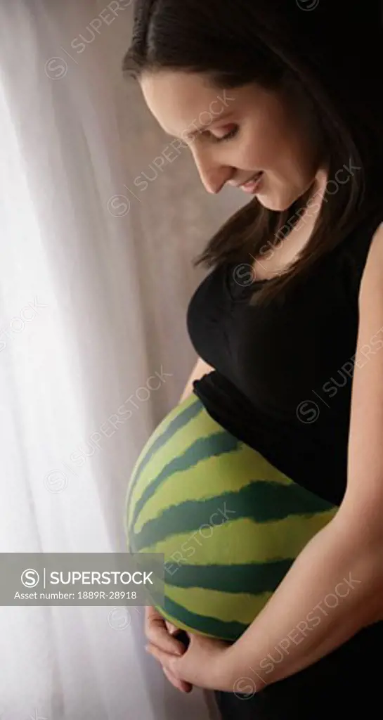 Pregnant woman with a painted stomach