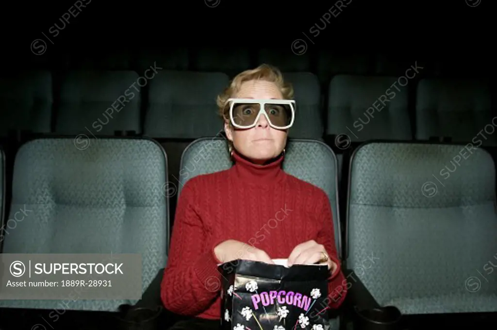 Woman sitting in a movie theater