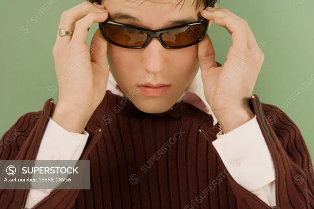 Man adjusting his sunglasses
