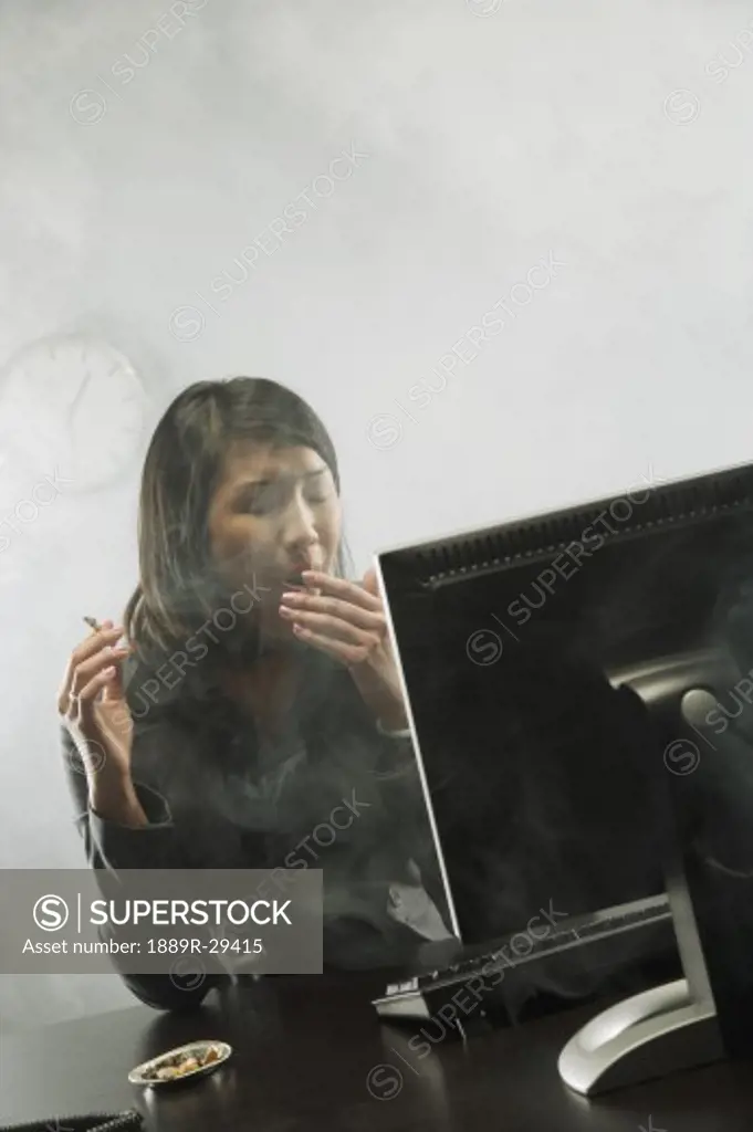 Female smoking in office