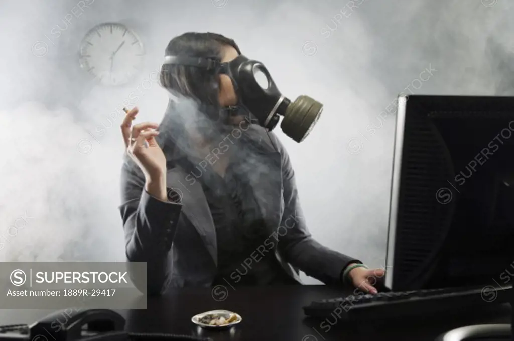 Woman smoking with a gas mask