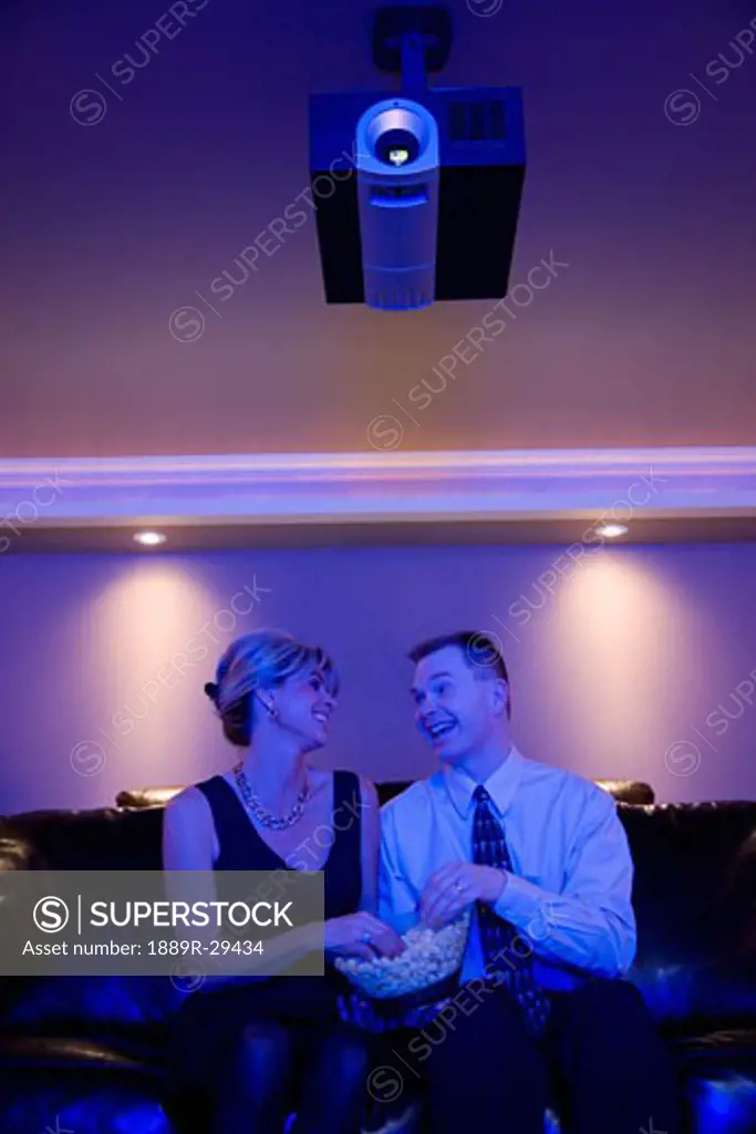 Couple looking at each other in front of movie