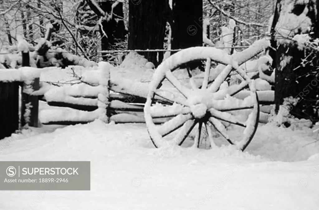 Wagon wheel covered in snow