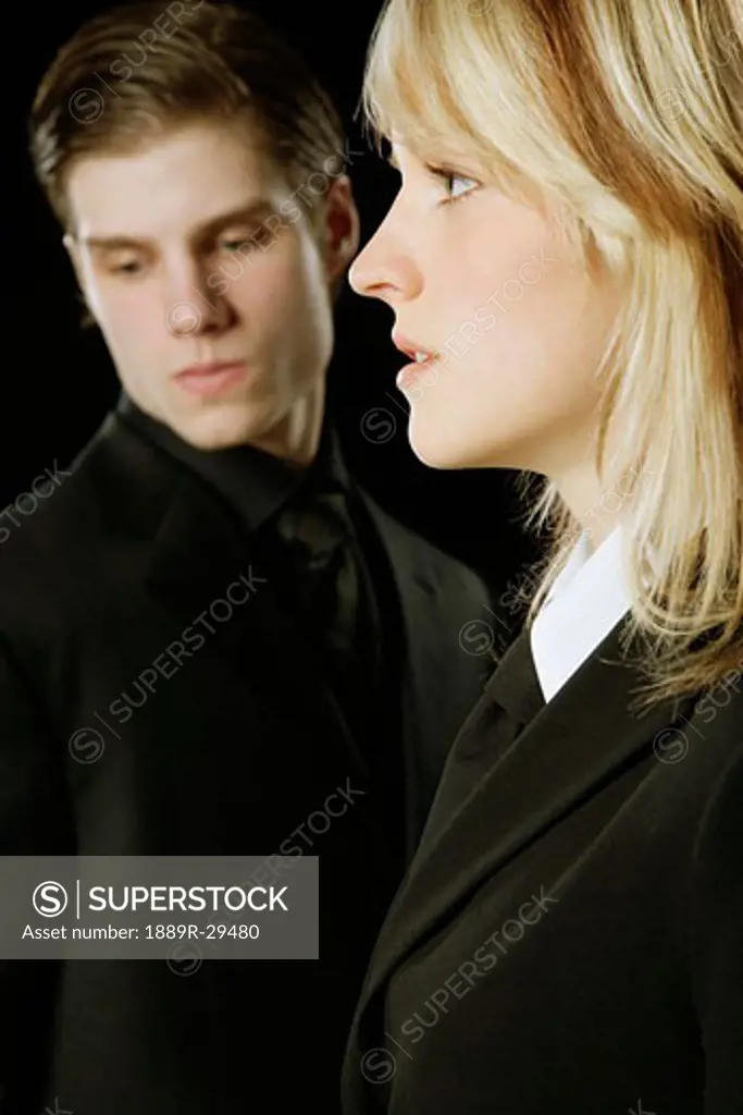 Young Adult male & female in suits