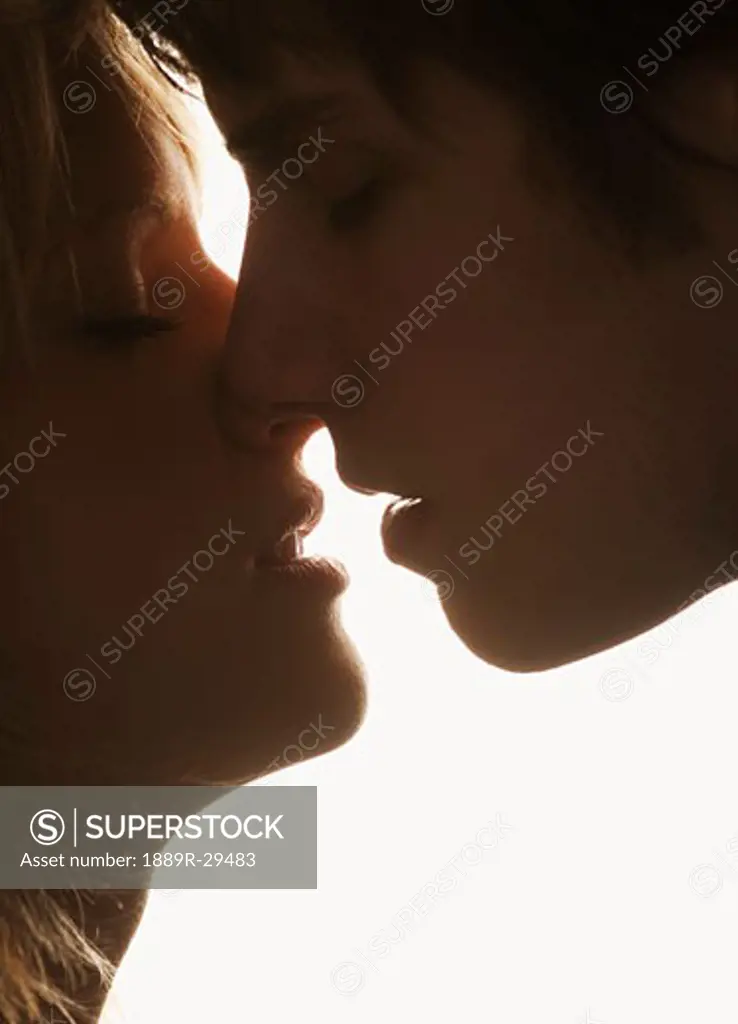 Young male and female about to kiss