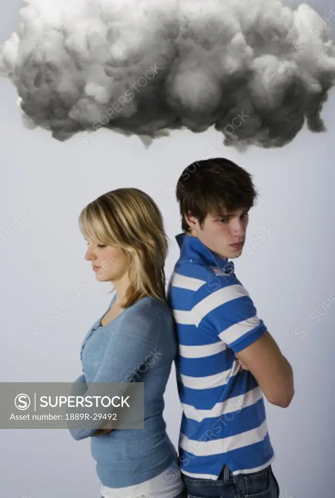 Male and female under dark cloud