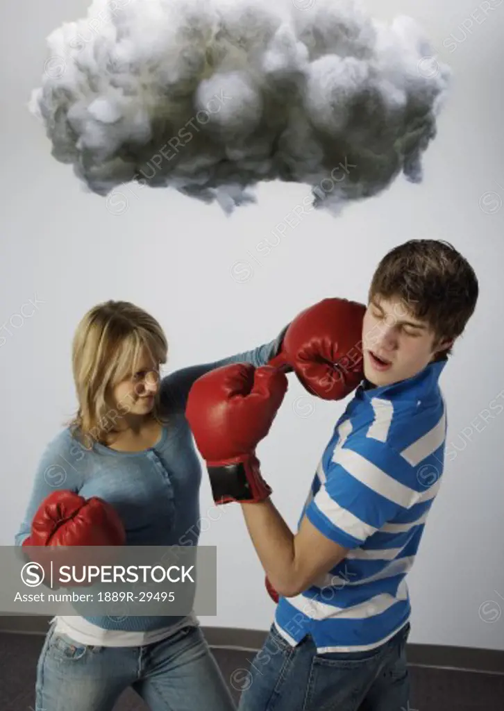 Male and female with boxing gloves under cloud
