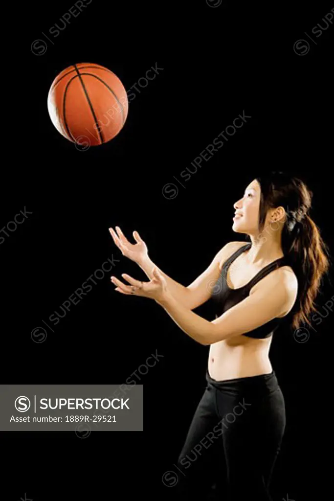 Woman throwing basketball