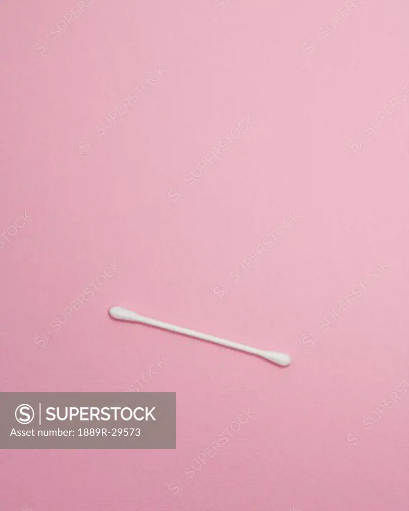 One Cotton Swab On Pink Surface
