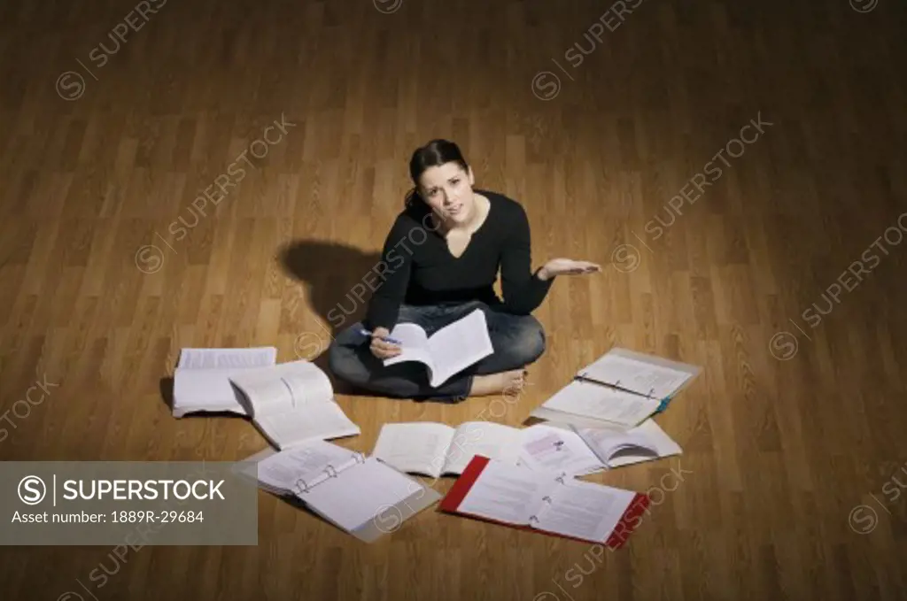Woman sitting on the floor studying