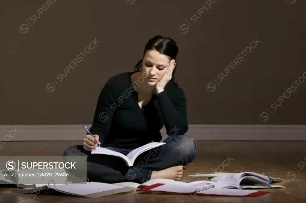 Woman studying on the floor
