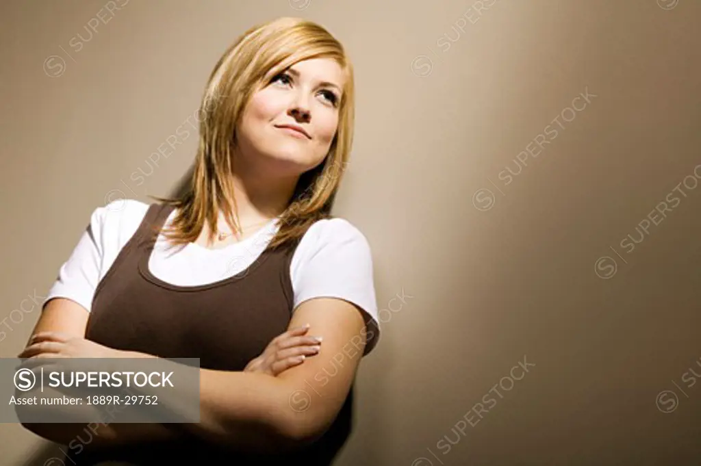 Blonde woman leaning against wall