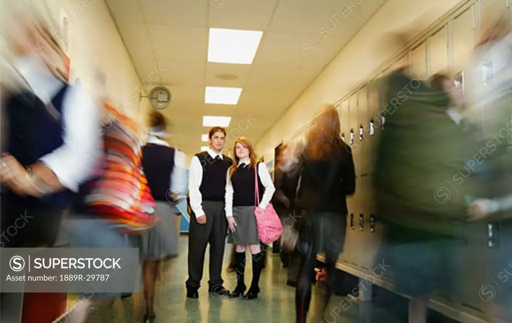 Standing still in a busy high school hallway