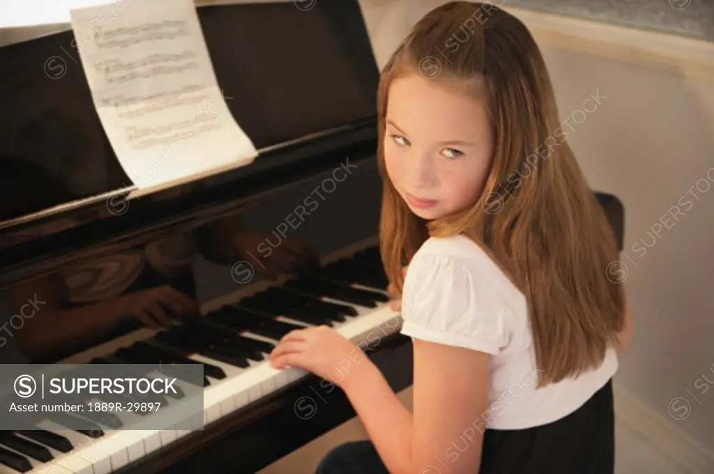 Girl practising piano  