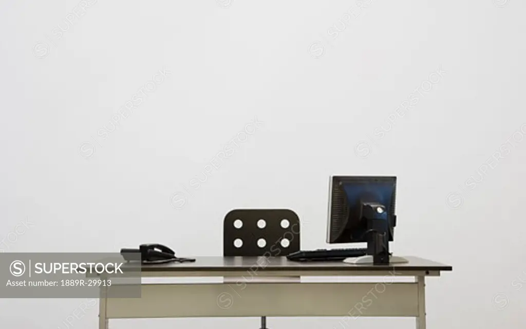 Office desk with computer and phone
