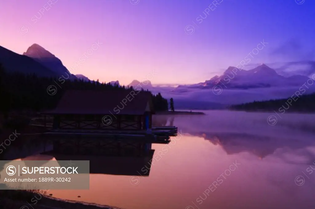 Foggy mountain sunrise on a lake  