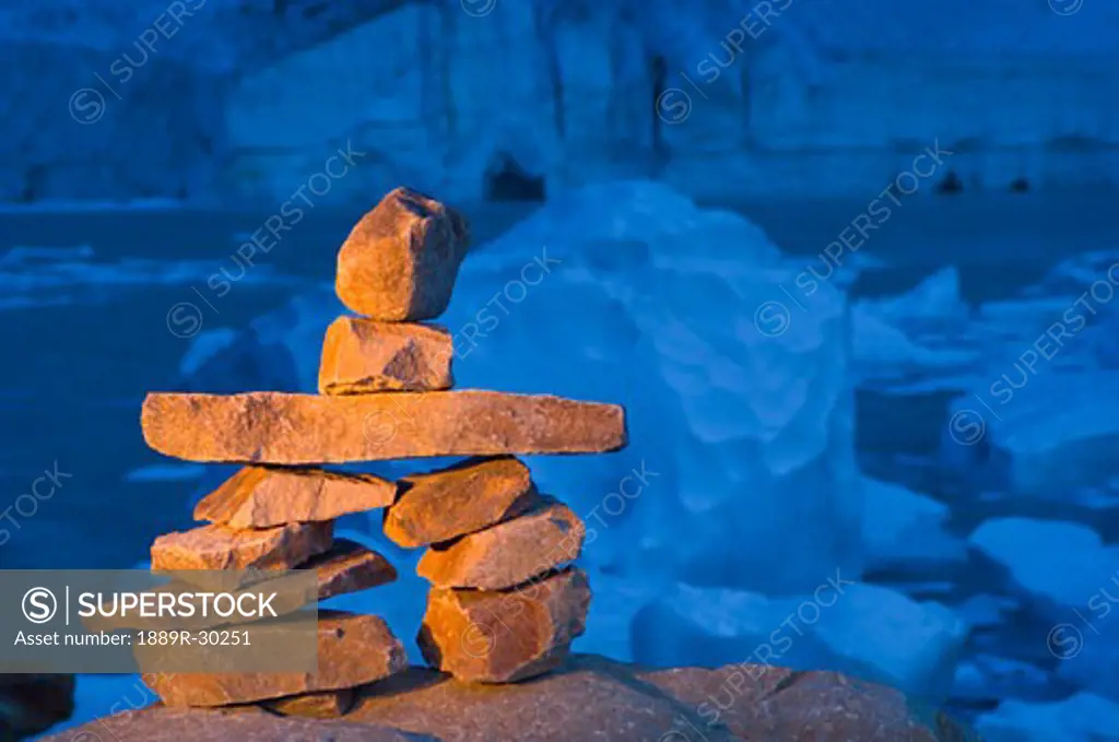 Cairn in front of glacier, ice cave and mountain  