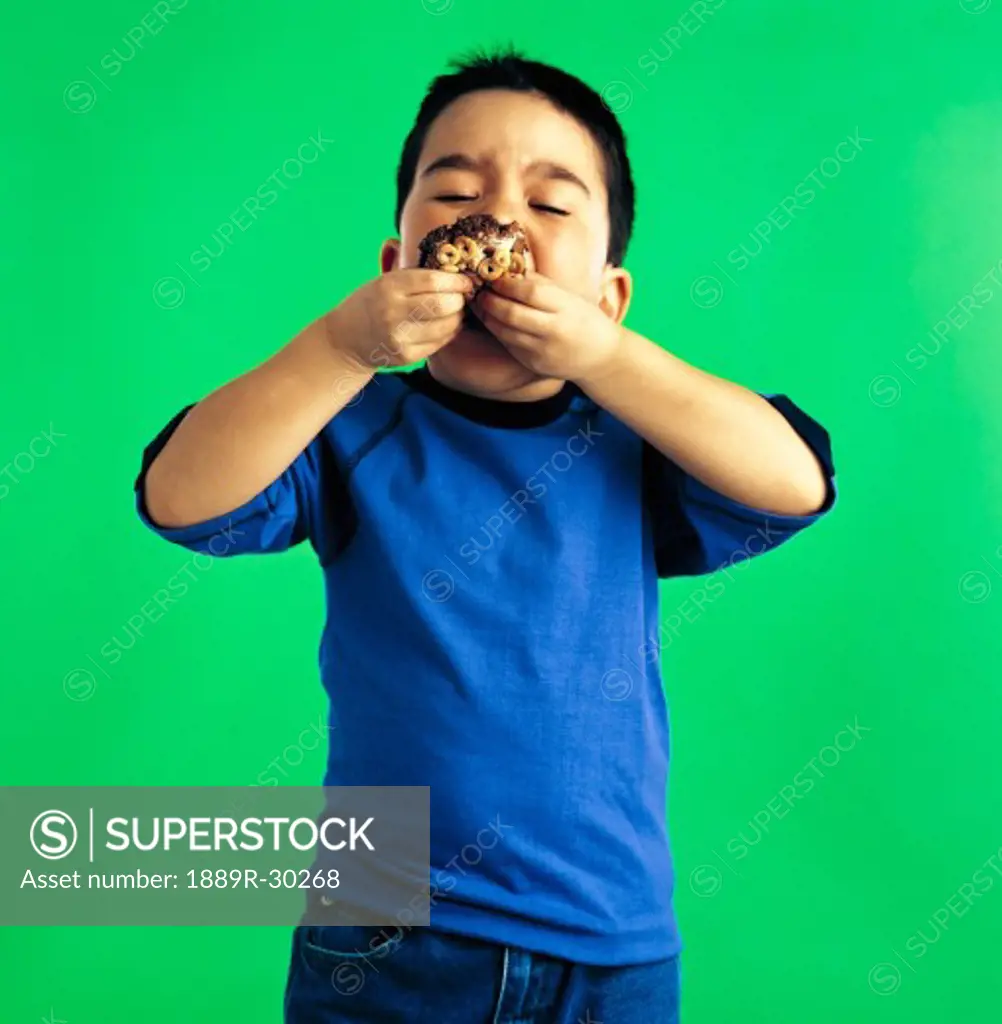 Young boy eating a cookie
