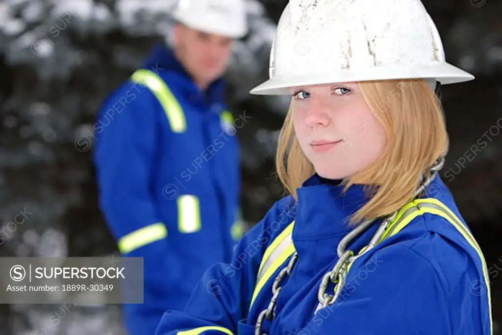 Tradeswoman with tradesman out of focus