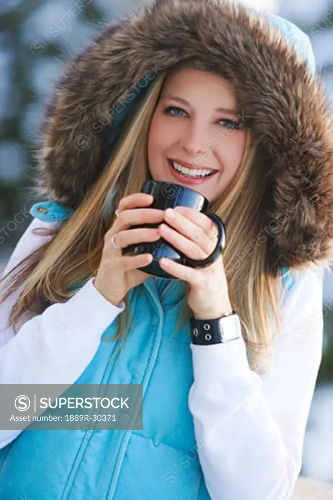 Woman drinking hot drink outside
