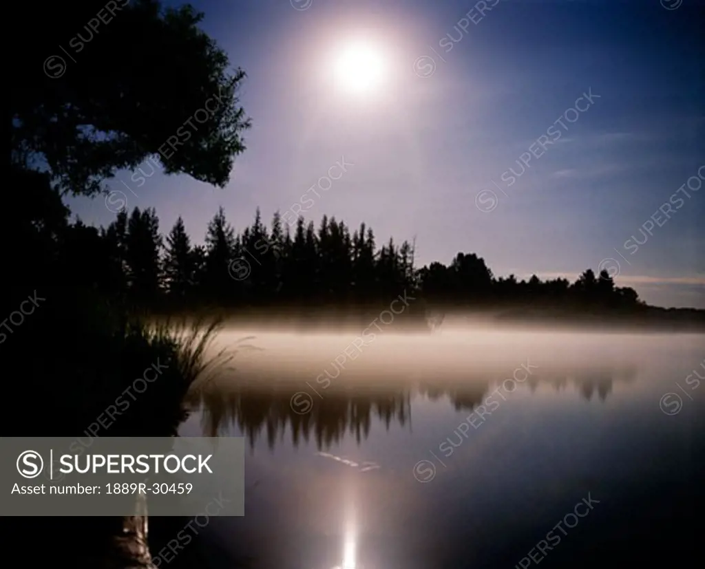 Moonlight on misty lake  