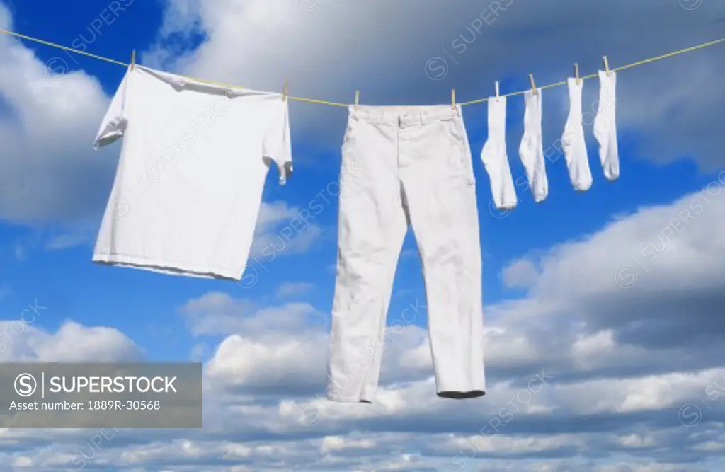 White clothes hanging on clothes line  