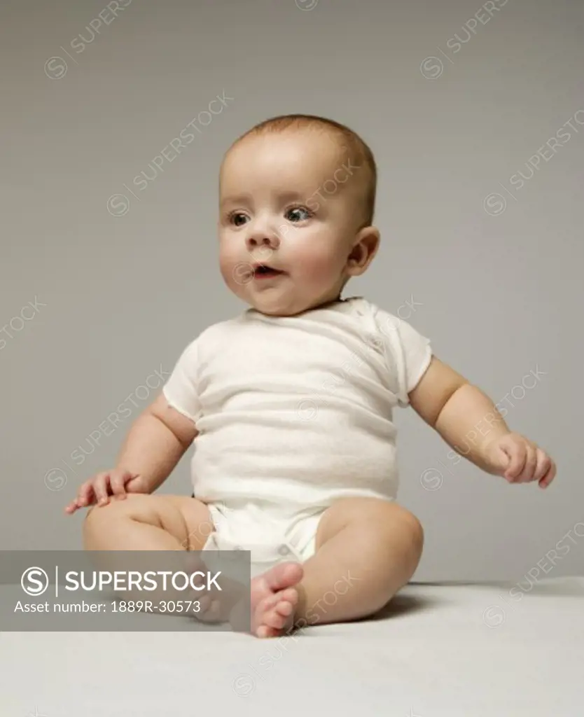 One cute baby learning to sit upright