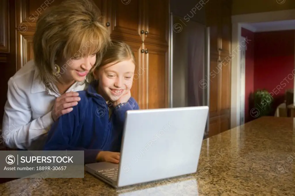 Mother and daughter using computer
