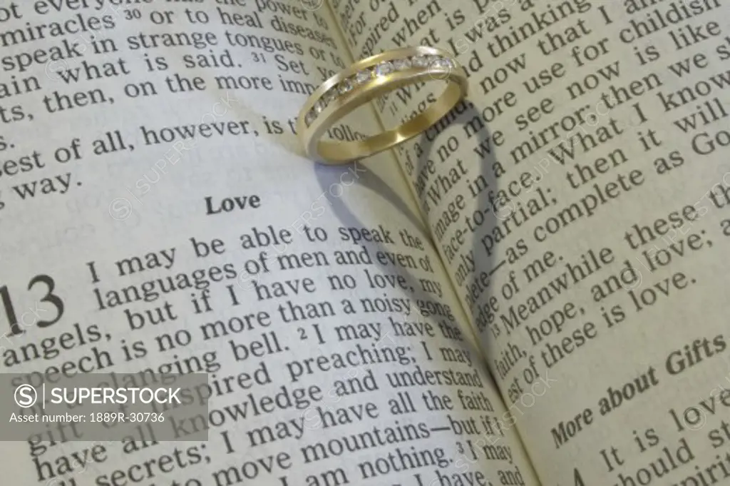 A wedding ring on an open Bible