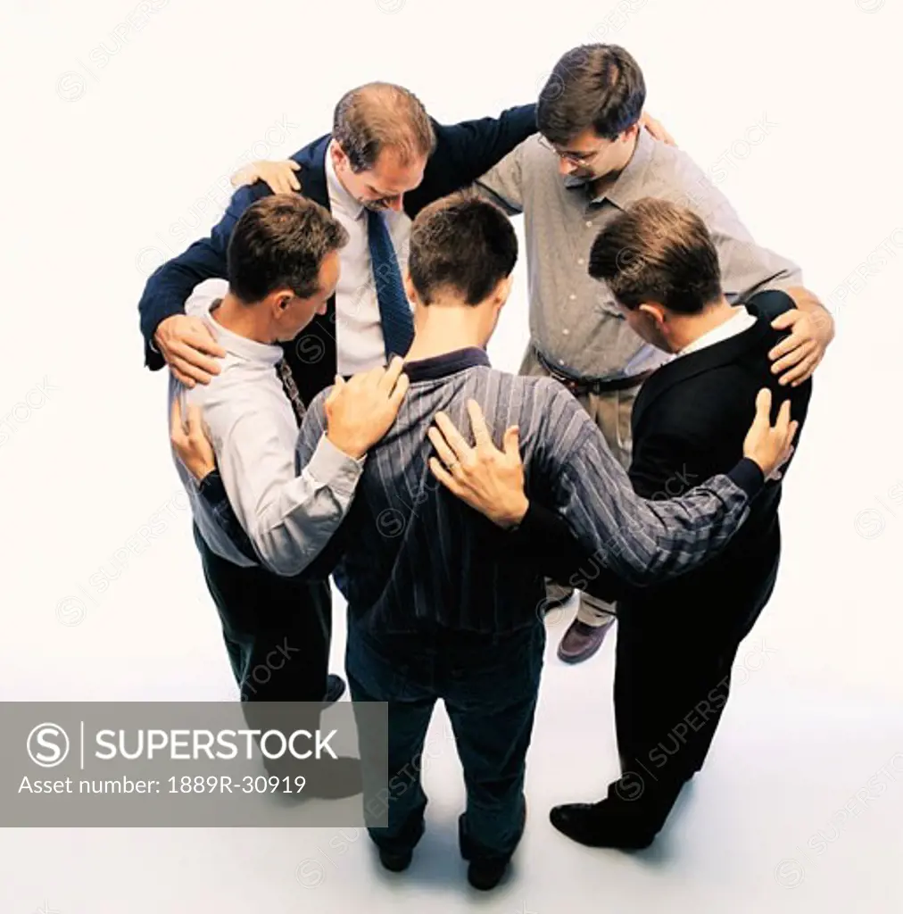 Group of business people praying together